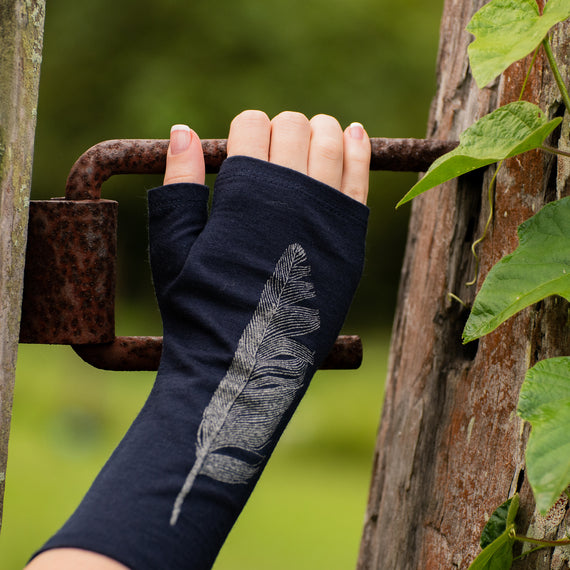 Beautiful Fingerless Merino Wool Glove on a womans hand, grabbing an iron fence.