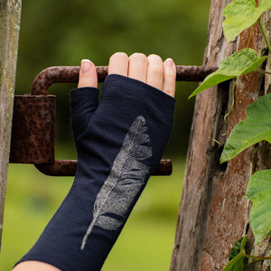 Beautiful Fingerless Merino Wool Glove on a womans hand, grabbing an iron fence.
