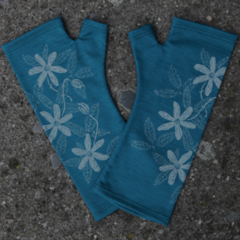 Blue Merino wool gloves on the ground. Hand made in New Zealand.